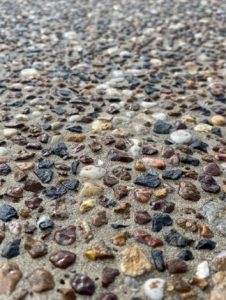 Exposed aggregate concrete surface with gravel and pebbles